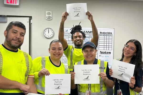 Piedmont members hold solidarity signs