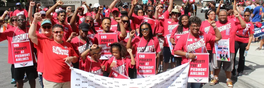 Group of Piedmont workers holding a banner.