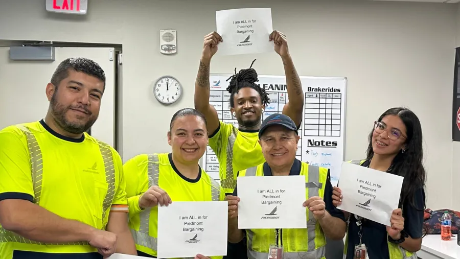 Piedmont members hold solidarity signs